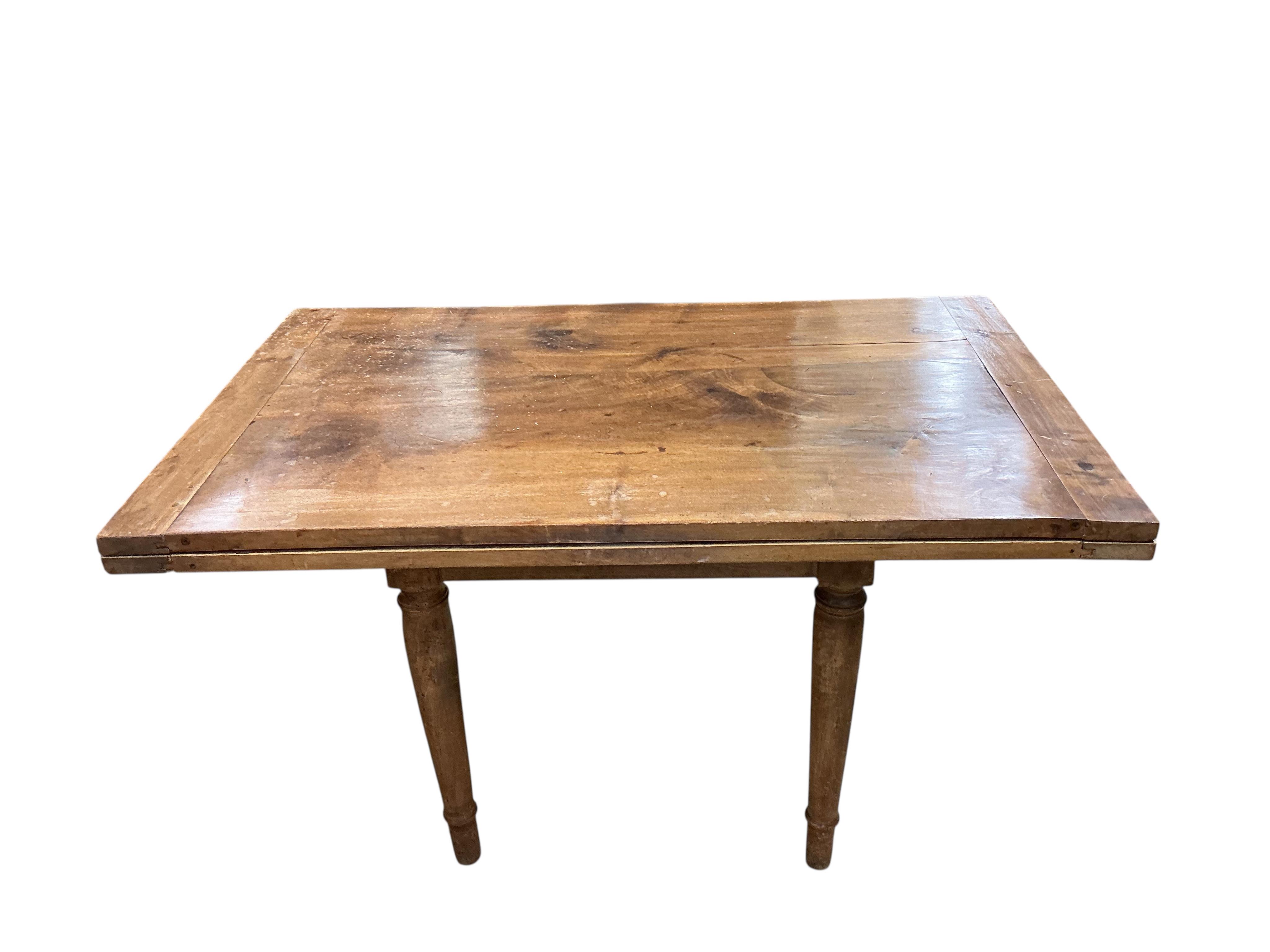A 19th century French folding fruitwood kitchen table, width 117cm, depth 72cm, height 74cm